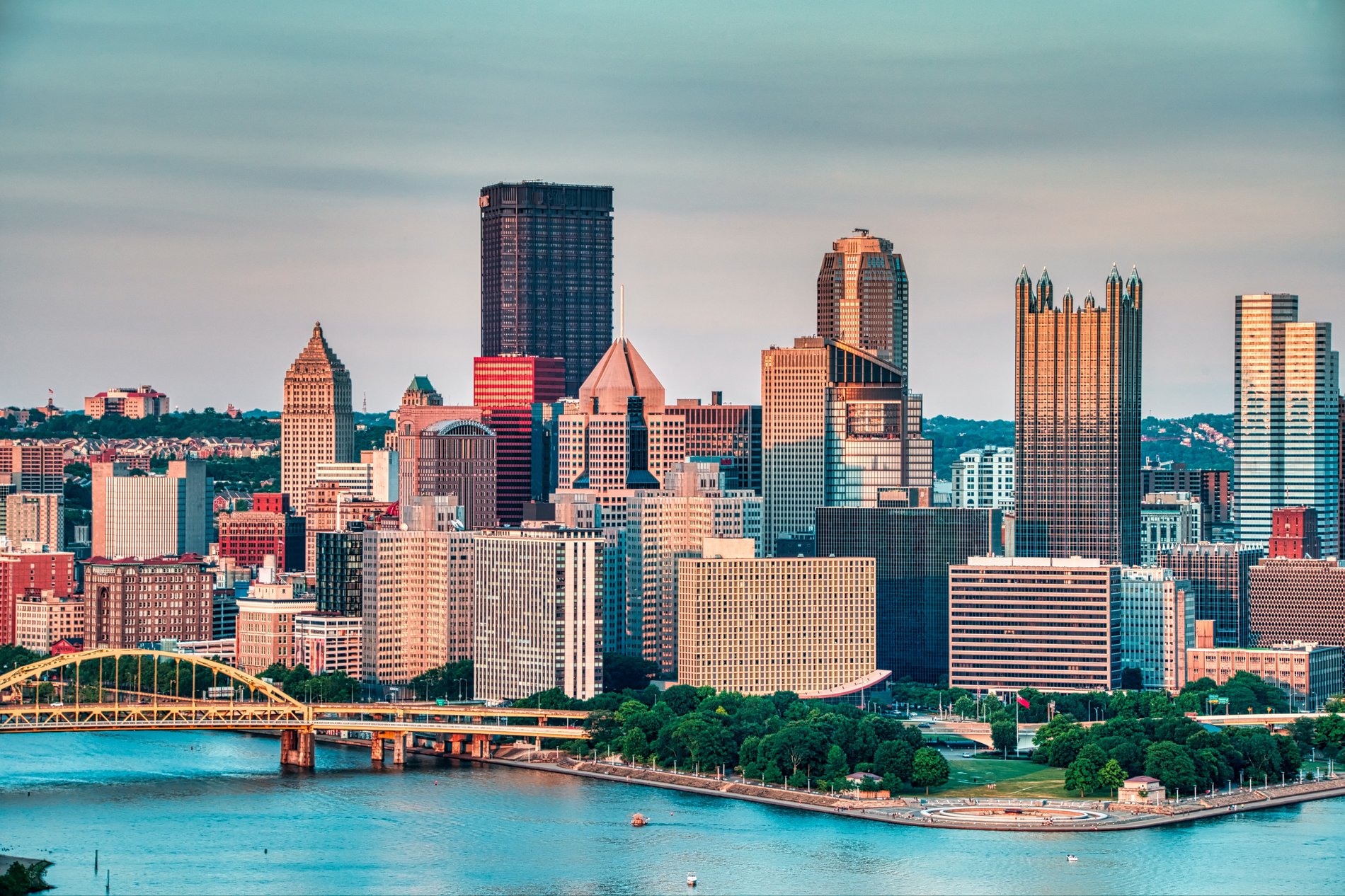 Aerial view of downtown Pittsburgh at sunset, with our new dealership location just north of the city